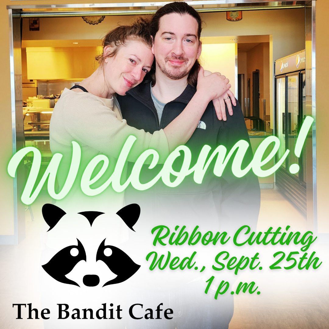 Wade and Kendall smile at the camara in front of the Bandit Cafe. Text says "Welcome, Ribbon Cutting Sept. 25th at 1 p.m.