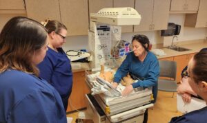 Nursing students utilize the radiant warmer donated by CMH during the OB/Maternal Newborn Simulation Lab